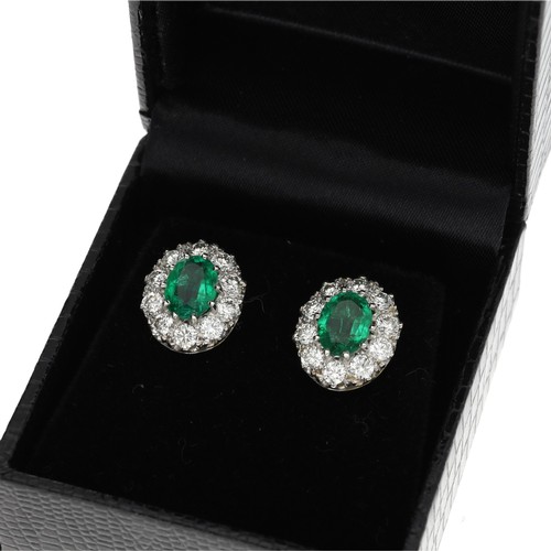 172 - Attractive pair of 18ct emerald and diamond oval cluster earrings, with oval emeralds each estimated... 