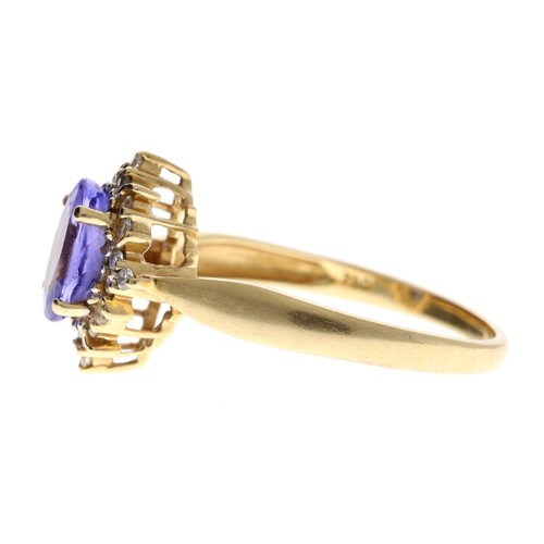 96 - Attractive 18ct tanzanite and diamond oval cluster ring, the tanzanite 1.20ct approx, round brillian... 