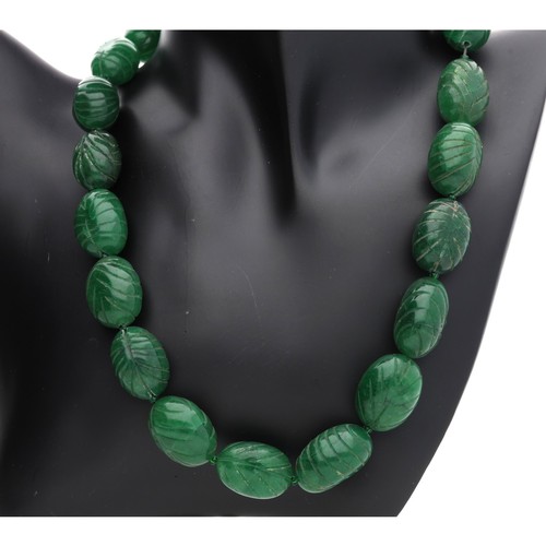 54 - Large and heavy carved reconstituted emerald bead necklace with a rose coloured toggle clasp, the be... 