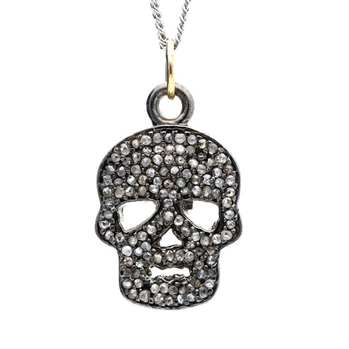 104 - Diamond set skull pendant in silver and silver gilt on a silver chain, the diamonds 0.40ct approx in... 