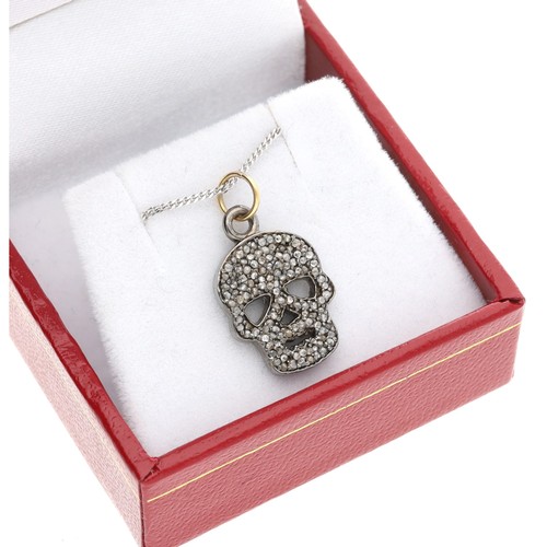 104 - Diamond set skull pendant in silver and silver gilt on a silver chain, the diamonds 0.40ct approx in... 