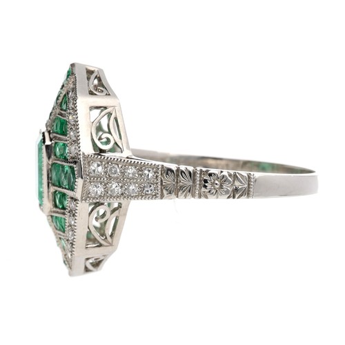 124 - Ornate platinum emerald and diamond dress ring in the Art Deco style, the central step-cut emerald 0... 