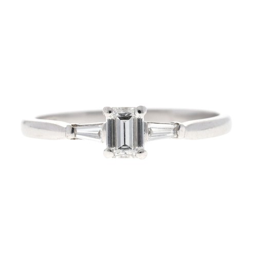 179 - Good 18ct white gold emerald and tapered baguette-cut three stone diamond ring, the emerald-cut 0.25... 