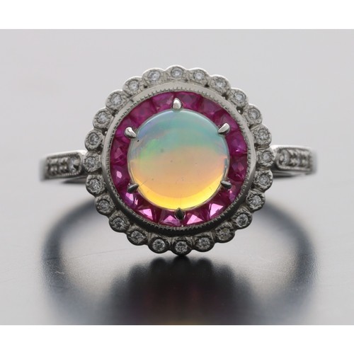 63 - Attractive platinum cabouchon opal, ruby and diamond circular cluster ring with set shoulders, 13mm ... 