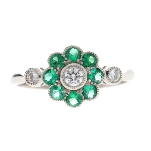 83 - Attractive platinum emerald and diamond cluster ring, the emeralds 0.40ct approx in total, round bri... 