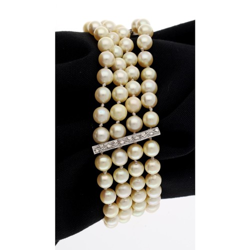 37 - Cultured pearl four strand bracelet, with white gold spacer mounts, each row consisting of 27 unifor... 