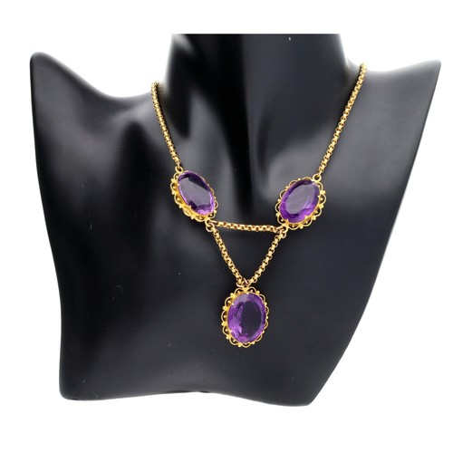 146 - Attractive antique 15ct amethyst necklace, with three oval amethyst on a belcher chain, the centre a... 