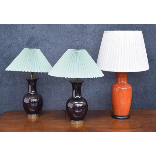 580 - Pair of pottery jar table lamps; together with a taller orange porcelain jar table lamp (3)... 