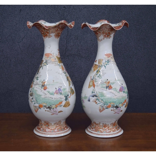 640 - Pair of Japanese porcelain vases, with wide wavy rims and figural panels within borders of topical i... 