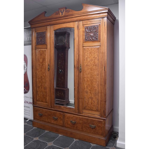 781 - Victorian Pollard oak wardrobe, with a broken arched pediment over a central long mirrored glass fla... 