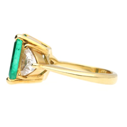 293 - Fine 18ct yellow gold emerald ring with trilliant-cut diamond shoulders, the emerald 12mm x 9mm, the... 