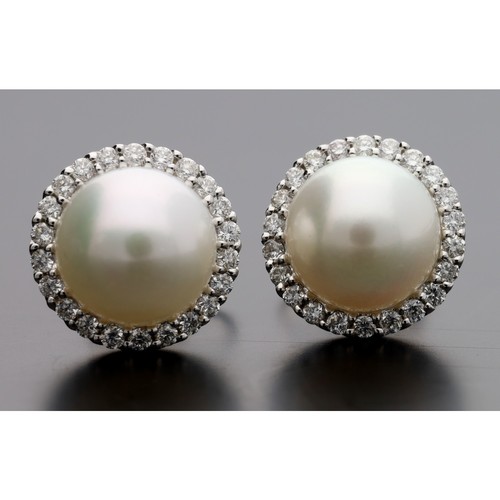 263 - Pair of 18ct white gold cultured pearl and diamond stud earrings, the pearls 8mm, in a border of rou... 