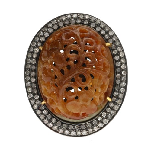 287 - Large diamond and brown jade oval ring, the jade with foliate pierced carving in a pavé diamond doub... 