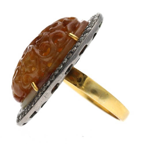 287 - Large diamond and brown jade oval ring, the jade with foliate pierced carving in a pavé diamond doub... 