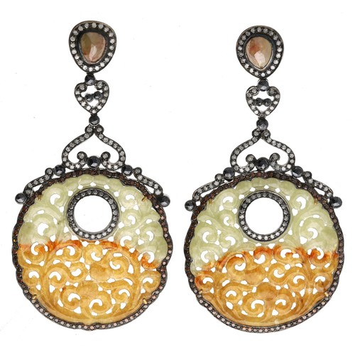 262 - Pair of impressive diamond and jade drop earrings, each with circular pierced carved discs and round... 