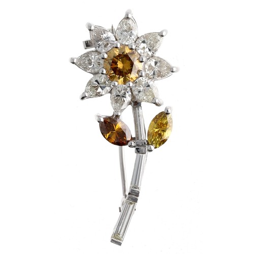 329 - 18ct white gold diamond set flower brooch, set with three fancy coloured diamonds and eight pear-cut... 