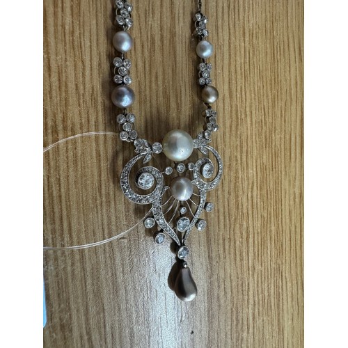 305 - Fine antique white metal diamond and pearl drop necklace, set with old-cut diamonds in a scroll open... 