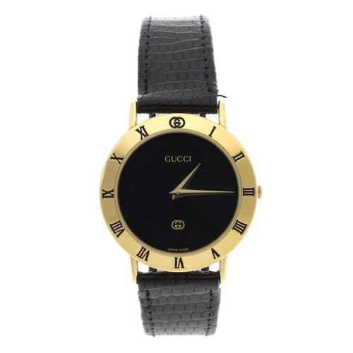 709 - Gucci 3000M gold plated wristwatch, circular black dial, Gucci black leather strap with signed buckl... 