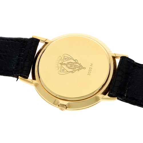 709 - Gucci 3000M gold plated wristwatch, circular black dial, Gucci black leather strap with signed buckl... 