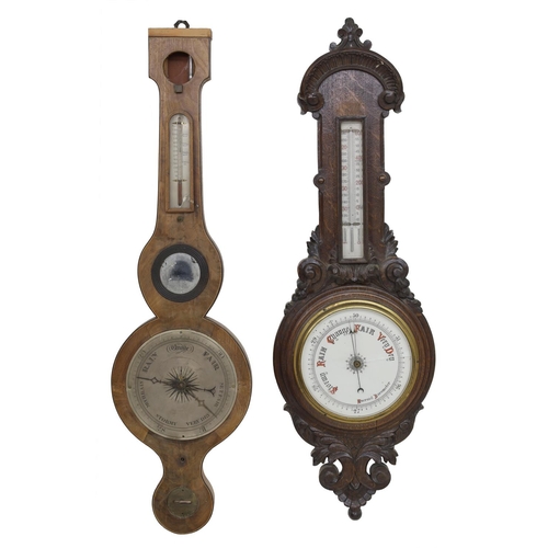 1002 - Aneroid barometer/thermometer within a foliate carved oak case; also a five glass mahogany wheel bar... 