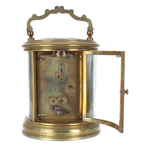 1233 - French oval carriage clock timepiece, the circular dial within a gilt mask and pillared stepped case... 