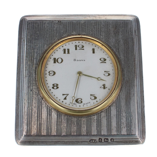 2503 - Small Swiss eight days travelling easel clock timepiece, within a striped silvered square case with ... 