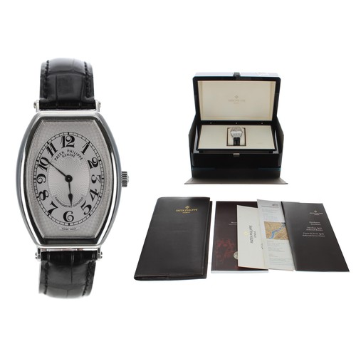 Fine Patek Philippe Gondolo platinum gentleman's wristwatch, reference no. 5098P-001, movement no. 3708xxx/4438xxx. circa 2008, silvered dial with Arabic numerals in a tonneau case, exhibition back with a 25-21/176 18 jewel movement, calibre movement, PP black crocodile strap with a platinum buckle, 32mm    