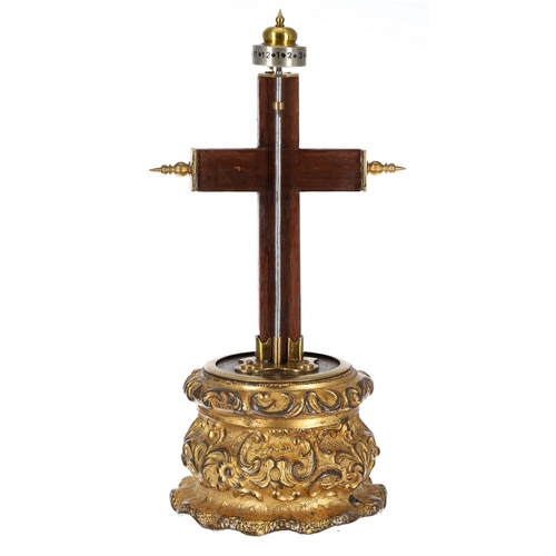 1305 - Small crucifix clock, the wooden cross surmounted by a horizontal silvered twelve hour chapter ring ... 