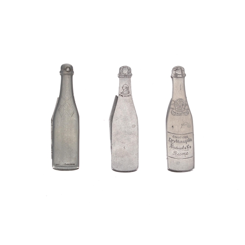 653 - Three novelty Champagne penknives, modelled as branded bottles including Moet & Chandon (3)... 