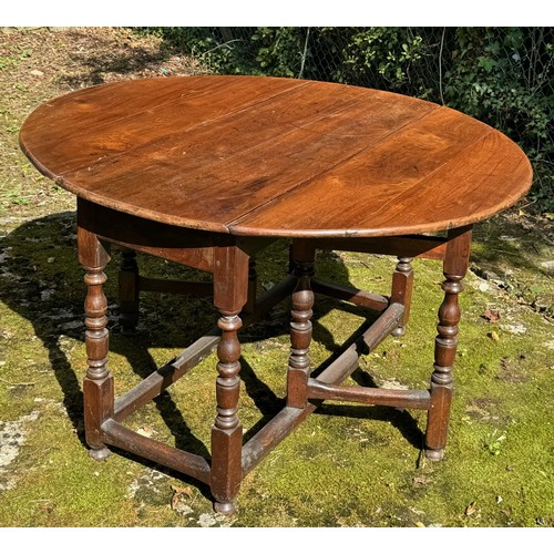 1350 - 18th century elm oval gateleg dropleaf dining table, with a single frieze end drawer and upon balust... 