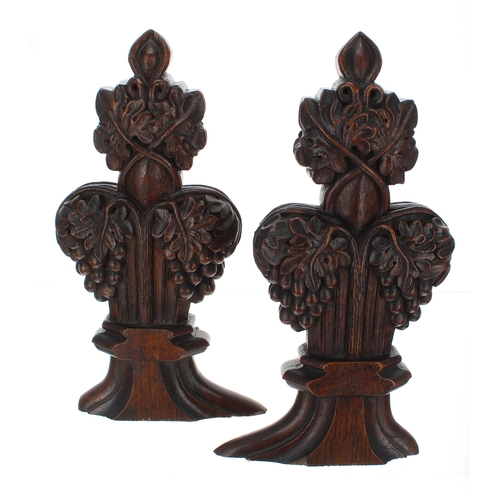 907 - Pair of carved oak pew end poppy-head finials, 15