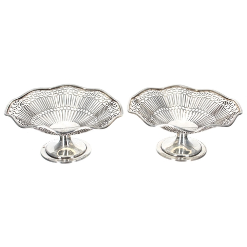 562 - Two pairs of similar silver sweetmeat baskets, with wavy edges raised on pedestal supports, makers G... 