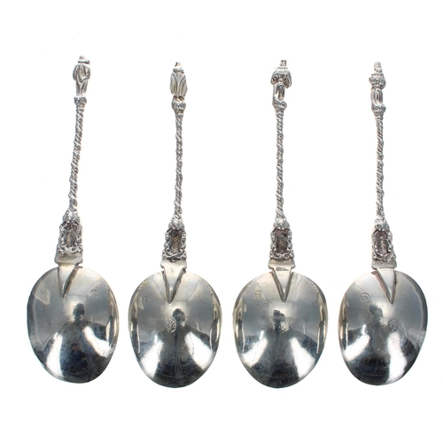 595 - Four Dutch silver apostle finial spoons, each with a twist cast handle and figural finial, each bear... 