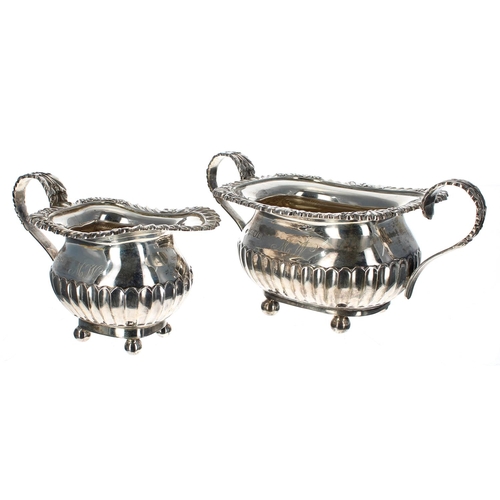 600 - Edwardian silver three piece tea set, the teapot with a hardwood handle, the others with foliate cas... 