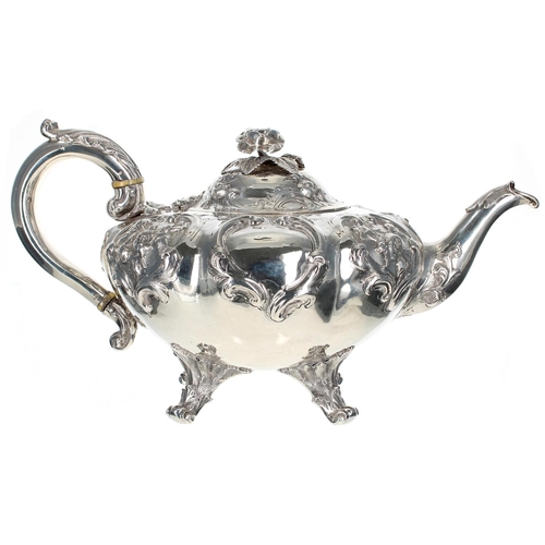 615 - Victorian silver teapot of melon form, with a leaf cast handle and hinged cover with a rose finial o... 