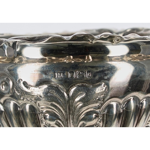 624 - Edwardian repoussé silver bowl, with foliate cast rim and stylised leaf decorated body, raised on a ... 