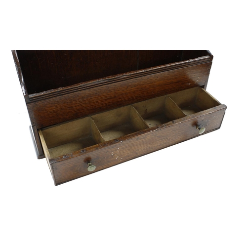 704 - 18th / 19th century oak Welsh spoon rack, the shaped back over an open box base with a slim drawer, ... 