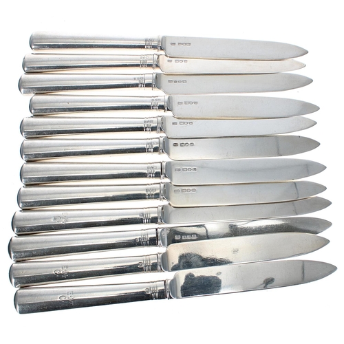 584 - Set of twelve George V silver fruit knives and forks, the loaded handles initialled E.M.C, maker R &... 