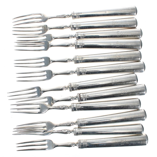 584 - Set of twelve George V silver fruit knives and forks, the loaded handles initialled E.M.C, maker R &... 