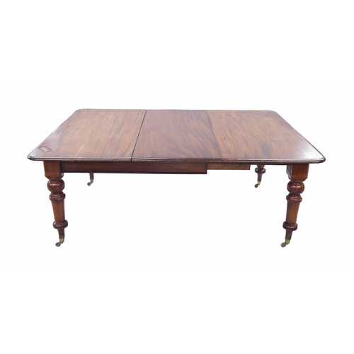 1435 - Victorian mahogany extending dining table, the moulded top upon turned legs terminating with brass c... 