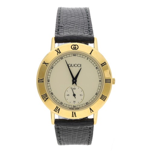 69 - Gucci gold plated gentleman's wristwatch, reference 3000.2.M, quartz, black leather strap with a Guc... 