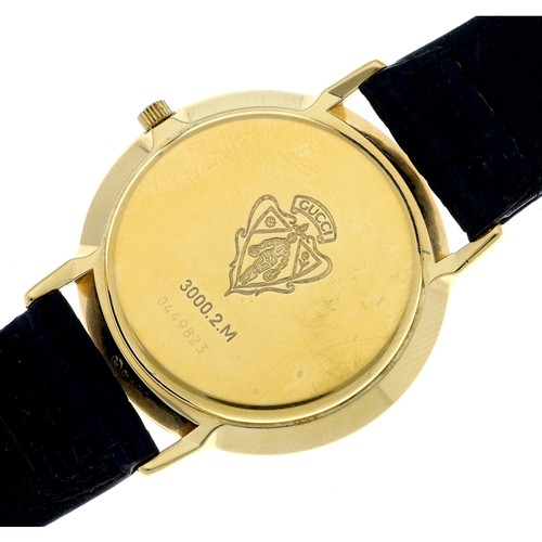 69 - Gucci gold plated gentleman's wristwatch, reference 3000.2.M, quartz, black leather strap with a Guc... 