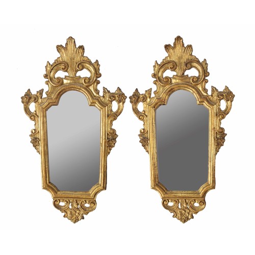 973 - Pair of Giltwood mirror sin the Georgian style, the shaped glass within moulded frames surmounted by... 