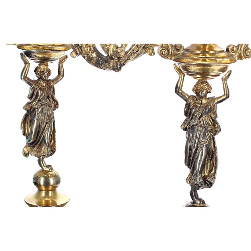 643 - Pair of decorative gilt brass figural twin-branch candelabra, the two sconces on foliate cast branch... 