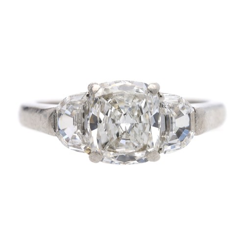 Fine GIA Certified three stone diamond ring, the centre certified diamond modified cushion brilliant, 1.63ct, clarity internally flawless, colour E, with two half-moon brilliant-cut diamonds to either side, width 8mm, 6.3gm, L (ref.233)