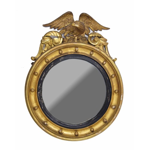 976 - Regency style gilt framed convex circular wall mirror, surmounted by an eagle, 31