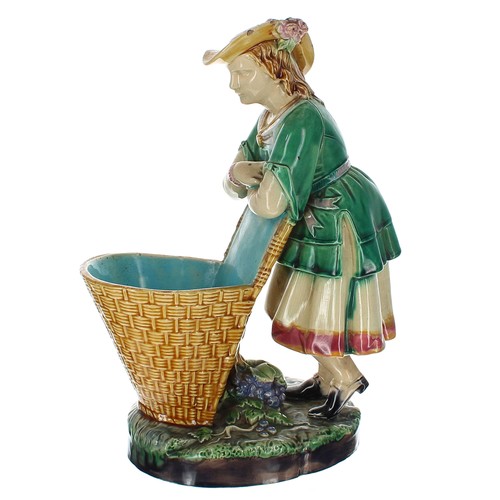 1302 - Minton 19th century majolica figure as a fruit picker, modelled leaning on her grape basket upon a f... 