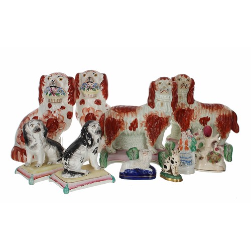 1286 - Pair of 19th century Staffordshire seated spaniels holding baskets of flowers, 8