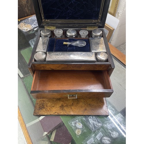 714 - Victorian walnut vanity travelling case, the hinged cover with brass presentation plaque enclosing a... 