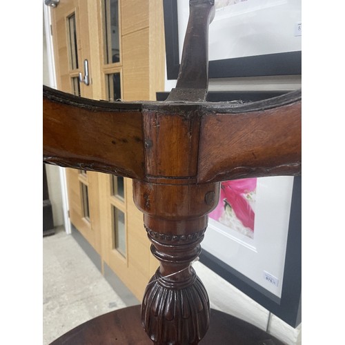 915 - George III mahogany tilt-top tripod occasional table, the tilt-top on a gadrooned central support on... 